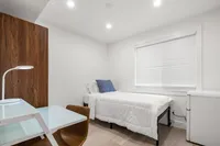 Bedroom with a spacious layout, soft lighting, and a calm, inviting atmosphere.