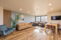 Bright and inviting living area with modern furnishings, stylish decor, and natural light streaming through large windows.