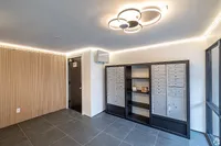 Mailroom with lockers and modern lighting in a stylish apartment building.