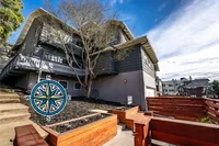 Charming multi-level home with unique architectural design and a cozy, welcoming atmosphere, surrounded by lush greenery and a serene neighborhood setting.