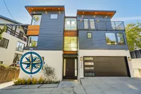 Contemporary three-story home with sleek modern design, large windows, and inviting curb appeal.