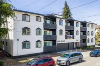 Modern apartment building with multiple balconies and ample parking, featuring a stylish exterior design at Park Place.