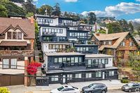Charming hillside apartments with a mix of modern and traditional architecture, featuring lush greenery and scenic neighborhood views.