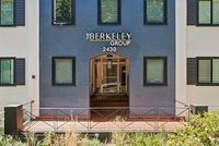 Charming building entrance of The Berkeley Group with modern facade and lush landscaping.