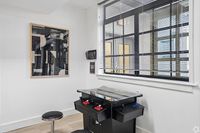 Game room corner with a sleek arcade machine and modern artwork, perfect for entertaining and relaxation.