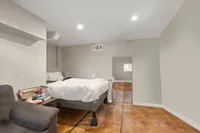 Cozy bedroom featuring stylish modern decor, a comfortable bed, and soft lighting.