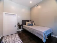 Cozy bedroom with a modern gray bed, and stylish pillows.