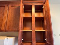 Beautifully crafted wooden kitchen cabinet with ample shelving, ideal for maximizing storage and enhancing kitchen elegance.