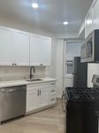 Sleek modern kitchen with stainless steel appliances, elegant white cabinetry, and stylish marble countertops.