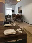 Elegant open-concept living area with stylish dining setup, featuring a cozy seating arrangement and modern decor.