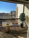 Charming balcony with cozy seating, vibrant décor, and scenic views, perfect for relaxation.