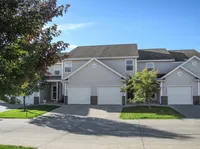 Charming suburban townhouse with modern architecture, two-story design, and spacious garage entry.