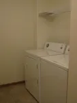 Sleek in-unit laundry room with modern washer and dryer, perfect for convenience and efficiency.