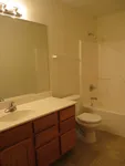 Inviting bathroom with modern fixtures, elegant vanity, and a spacious shower-tub combo.