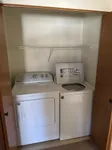 Convenient in-unit laundry closet with modern washer and dryer, optimized for efficient living.