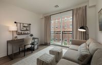 Embrace urban elegance in this beautifully designed apartment space featuring work and relaxation areas.