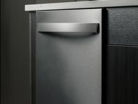 Sleek Whirlpool stainless steel dishwasher integrated into a modern kitchen design.