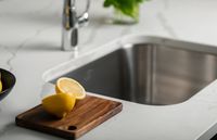 Modern kitchen sink with sleek chrome design, showcasing a stylish and functional space.