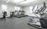 Our state-of-the-art fitness center offers everything you need for a complete workout experience. Bright, modern fitness center with state-of-the-art treadmills, exercise bikes, and strength training equipment.