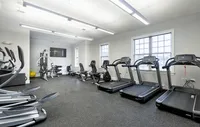Our state-of-the-art fitness center offers everything you need for a complete workout experience. Bright, modern fitness center with state-of-the-art treadmills, exercise bikes, and strength training equipment.