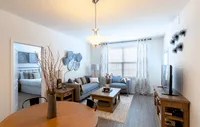 Modern, cozy living spaces with stylish décor, luxury flooring, and warm wood accents for a welcoming feel. Chic and inviting living room with stylish decor, comfortable seating, and a warm ambiance, perfect for relaxation and social gatherings.
