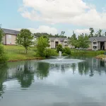 Experience peaceful living with a stunning view of the fountain and landscaped surroundings.