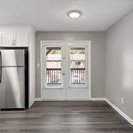 Experience elegance in this apartment's airy kitchen with stylish finishes and outdoor access.