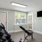 Elevate your fitness routine in this inviting home gym space, designed with your wellness in mind.