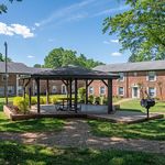 Relax and unwind in this serene courtyard, featuring a charming gazebo and vibrant landscaping.