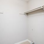Bright and spacious closet area with ample shelving, perfect for organized storage.