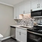 Modern kitchen with sleek stainless steel appliances, elegant white cabinetry, and a stylish tile backsplash.