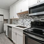 Modern kitchen with sleek stainless steel appliances, elegant white cabinetry, and stylish mosaic backsplash tiles.