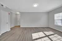 Bright and inviting living space with elegant hardwood floors and ample natural light.