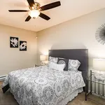 Inviting bedroom with elegant decor, featuring a plush bed, stylish wall art, and cozy lighting for ultimate relaxation.