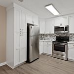 Modern kitchen with sleek stainless steel appliances, elegant white cabinetry, and a stylish backsplash for a contemporary feel.
