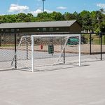 Inviting recreational area with a sports field and goalpost, perfect for outdoor activities in a sunny community setting.