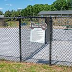 Inviting Bark Park with open space, perfect for playful dogs in a serene community setting.