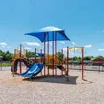 Vibrant playground with colorful slides and climbing structures, perfect for children to enjoy sunny days.