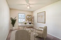 Bright and inviting home office with modern decor, featuring a sleek desk, cozy chairs, and natural light pouring in through the window.
