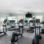 Modern fitness center with state-of-the-art treadmills and mirrored walls, offering a vibrant and motivating workout environment.
