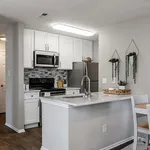 Modern kitchen with sleek stainless steel appliances, elegant marble countertop, and stylish tile backsplash.