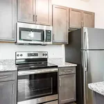 Modern kitchen with sleek stainless steel appliances, granite countertops, and stylish cabinetry.