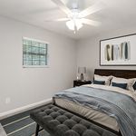Inviting modern bedroom with elegant decor, featuring a cozy bed, stylish artwork, and a soothing color palette.