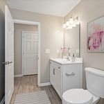 Modern bathroom with elegant vanity, stylish lighting, and tasteful decor, offering a serene and inviting atmosphere.