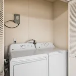 Convenient in-unit laundry with a modern washer and dryer set tucked in a cozy, well-lit alcove.