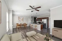 Bright modern living area featuring an open-concept kitchen with stainless steel appliances, cozy dining space, and elegant wood flooring.