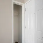 Bright and inviting entrance showcasing a sleek, modern interior closet with ample storage space.