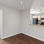 Contemporary apartment with sleek hardwood floors, open kitchen with modern appliances, and ambient lighting.