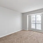 Bright and inviting empty room with plush carpet and a large window, perfect for transforming into a cozy bedroom or office space.
