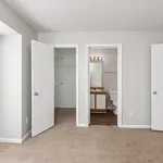 Bright and inviting bedroom with plush carpet, featuring a spacious closet and an en-suite bathroom for ultimate convenience.